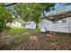 Exterior view of backyard with green lawn, shed, and propane tank at 5906 12Th St, Zephyrhills, FL 33542