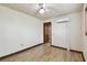 Bedroom with tiled floors, a ceiling fan, air conditioner, and access to another room at 5906 12Th St, Zephyrhills, FL 33542
