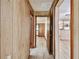Hallway with wood-paneled walls and tiled floors leading to other areas of the home at 5906 12Th St, Zephyrhills, FL 33542
