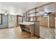 Open kitchen featuring a breakfast bar, wood-look flooring, and white appliances at 5906 12Th St, Zephyrhills, FL 33542