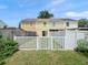 Fenced backyard featuring a combination of wood and vinyl fencing, plus an open lawn at 6114 Oak Cluster Cir, Tampa, FL 33634