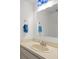 Clean bathroom features a built-in sink, large mirror, and bright lighting at 6114 Oak Cluster Cir, Tampa, FL 33634