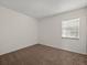 Cozy bedroom featuring neutral carpet, a window with blinds, and ample natural light at 6114 Oak Cluster Cir, Tampa, FL 33634