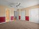 Spacious bedroom with carpet, ceiling fan, paneled walls and a closet at 6114 Oak Cluster Cir, Tampa, FL 33634