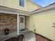 Charming porch with brick siding, providing curb appeal to the home's exterior at 6114 Oak Cluster Cir, Tampa, FL 33634