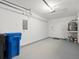 An attached garage with utility shelves and water heater at 6114 Oak Cluster Cir, Tampa, FL 33634