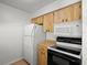 Kitchen featuring modern white appliances including a range, microwave, and refrigerator at 6114 Oak Cluster Cir, Tampa, FL 33634