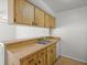 Kitchen area with wooden cabinets, a stainless sink and updated appliances at 6114 Oak Cluster Cir, Tampa, FL 33634