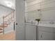 Convenient laundry area near stairs, complete with washer, dryer, and shelving at 6114 Oak Cluster Cir, Tampa, FL 33634