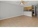 Open living area with tile flooring that flows seamlessly into the kitchen area at 6114 Oak Cluster Cir, Tampa, FL 33634