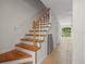 Staircase with wood banister and treads, leading to the home's upper level at 6114 Oak Cluster Cir, Tampa, FL 33634
