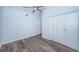 Bedroom with hardwood floors, a ceiling fan, and a built-in wardrobe with drawers at 6206 92Nd N Pl # 3605, Pinellas Park, FL 33782