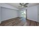 Comfortable bedroom with new flooring, ceiling fan, and sliding glass door at 6206 92Nd N Pl # 3605, Pinellas Park, FL 33782