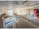 Bright community room with tables, chairs, ceiling fans, and a convenient vending machine at 6206 92Nd N Pl # 3605, Pinellas Park, FL 33782