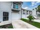 Townhome showing a private balcony, garage, and driveway with a small garden at 6206 92Nd N Pl # 3605, Pinellas Park, FL 33782