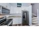 Modern kitchen with stainless steel appliances, granite countertops, and convenient stair access at 6206 92Nd N Pl # 3605, Pinellas Park, FL 33782