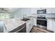 Bright kitchen boasts granite countertops, stainless appliances, and seamless access to living area at 6206 92Nd N Pl # 3605, Pinellas Park, FL 33782