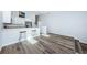 Bright, open kitchen with breakfast bar, stainless steel appliances, and modern wood flooring at 6206 92Nd N Pl # 3605, Pinellas Park, FL 33782