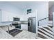 Modern kitchen with stainless steel appliances, granite countertops, and convenient stair access at 6206 92Nd N Pl # 3605, Pinellas Park, FL 33782
