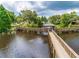 Scenic lake view with a charming wooden bridge and gazebo, surrounded by lush greenery at 6206 92Nd N Pl # 3605, Pinellas Park, FL 33782