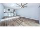 Large living area with hardwood floors, an open kitchen, skylights, and a modern ceiling fan at 6206 92Nd N Pl # 3605, Pinellas Park, FL 33782
