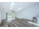 Spacious living room with skylights, ceiling fan, sliding doors to deck, and bar seating at kitchen at 6206 92Nd N Pl # 3605, Pinellas Park, FL 33782