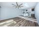 Spacious living room featuring hardwood floors, an open kitchen, and a unique ceiling fan at 6206 92Nd N Pl # 3605, Pinellas Park, FL 33782