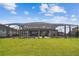 Spacious backyard featuring a screened-in pool area, ideal for outdoor enjoyment at 7024 Bradbury Cir, Wesley Chapel, FL 33545