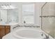 Bright bathroom featuring a large soaking tub and shower at 7024 Bradbury Cir, Wesley Chapel, FL 33545