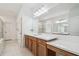 Bathroom with double sink vanity, soaking tub, and glass-enclosed shower at 7024 Bradbury Cir, Wesley Chapel, FL 33545