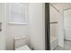 Clean bathroom showcases a toilet, shower-tub combo with shower curtain and tiled wall accent at 7024 Bradbury Cir, Wesley Chapel, FL 33545