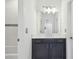 Nicely decorated bathroom boasts tiled shower-tub, vanity with cabinets and countertop and a large mirror at 7024 Bradbury Cir, Wesley Chapel, FL 33545