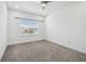 Bright bedroom with carpet floor features a window that provides ample natural light and a ceiling fan at 7024 Bradbury Cir, Wesley Chapel, FL 33545