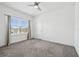 Inviting bedroom featuring neutral walls, plush carpet, recessed lights, and a window with sheer curtains at 7024 Bradbury Cir, Wesley Chapel, FL 33545