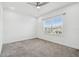 Spacious bedroom with neutral tones, plush carpeting, recessed lighting, and large windows for natural light at 7024 Bradbury Cir, Wesley Chapel, FL 33545