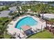 Bird's-eye view of a pristine community pool, furnished with loungers and cabanas at 7024 Bradbury Cir, Wesley Chapel, FL 33545