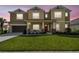 Inviting two-story home featuring a covered front porch and well-manicured lawn at 7024 Bradbury Cir, Wesley Chapel, FL 33545