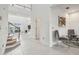 Bright foyer with tile flooring, staircase, and high ceilings leading into the living area at 7024 Bradbury Cir, Wesley Chapel, FL 33545