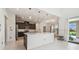 Modern kitchen with a large center island, stainless steel appliances, and access to the lanai at 7024 Bradbury Cir, Wesley Chapel, FL 33545