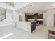 Modern kitchen with a large center island, stainless steel appliances, and open to the living room at 7024 Bradbury Cir, Wesley Chapel, FL 33545