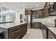Modern kitchen with stainless steel appliances, and dark wood cabinets at 7024 Bradbury Cir, Wesley Chapel, FL 33545