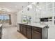 Open kitchen with oversized island, stainless appliances, and unique mirrored wall detail at 7024 Bradbury Cir, Wesley Chapel, FL 33545