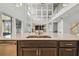 Close up of kitchen island with stainless steel dishwasher and unique mirrored wall detail at 7024 Bradbury Cir, Wesley Chapel, FL 33545