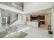 Open-plan living space featuring soaring ceilings, a modern staircase, and views into the kitchen at 7024 Bradbury Cir, Wesley Chapel, FL 33545