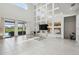 Open concept living room features lots of natural light with tile floors and mirrored accent wall at 7024 Bradbury Cir, Wesley Chapel, FL 33545