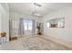 Spacious, bright living room featuring neutral walls, tile floors, and modern chandelier at 7024 Bradbury Cir, Wesley Chapel, FL 33545