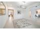 Spacious, bright living room featuring neutral walls, tile floors, and modern chandelier at 7024 Bradbury Cir, Wesley Chapel, FL 33545