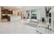 Bright, open-plan living room featuring tile floors, and sliding doors to the outdoor living space at 7024 Bradbury Cir, Wesley Chapel, FL 33545
