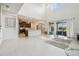 Open concept living area with tile floor, kitchen, and exterior view of the patio at 7024 Bradbury Cir, Wesley Chapel, FL 33545