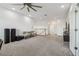 Carpeted loft space provides ample seating and a view into an adjacent living area with TV at 7024 Bradbury Cir, Wesley Chapel, FL 33545